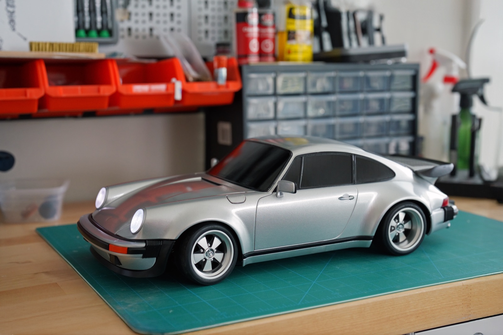 Finished silver 3D printed 930 RC body on the bench, front three-quarter view