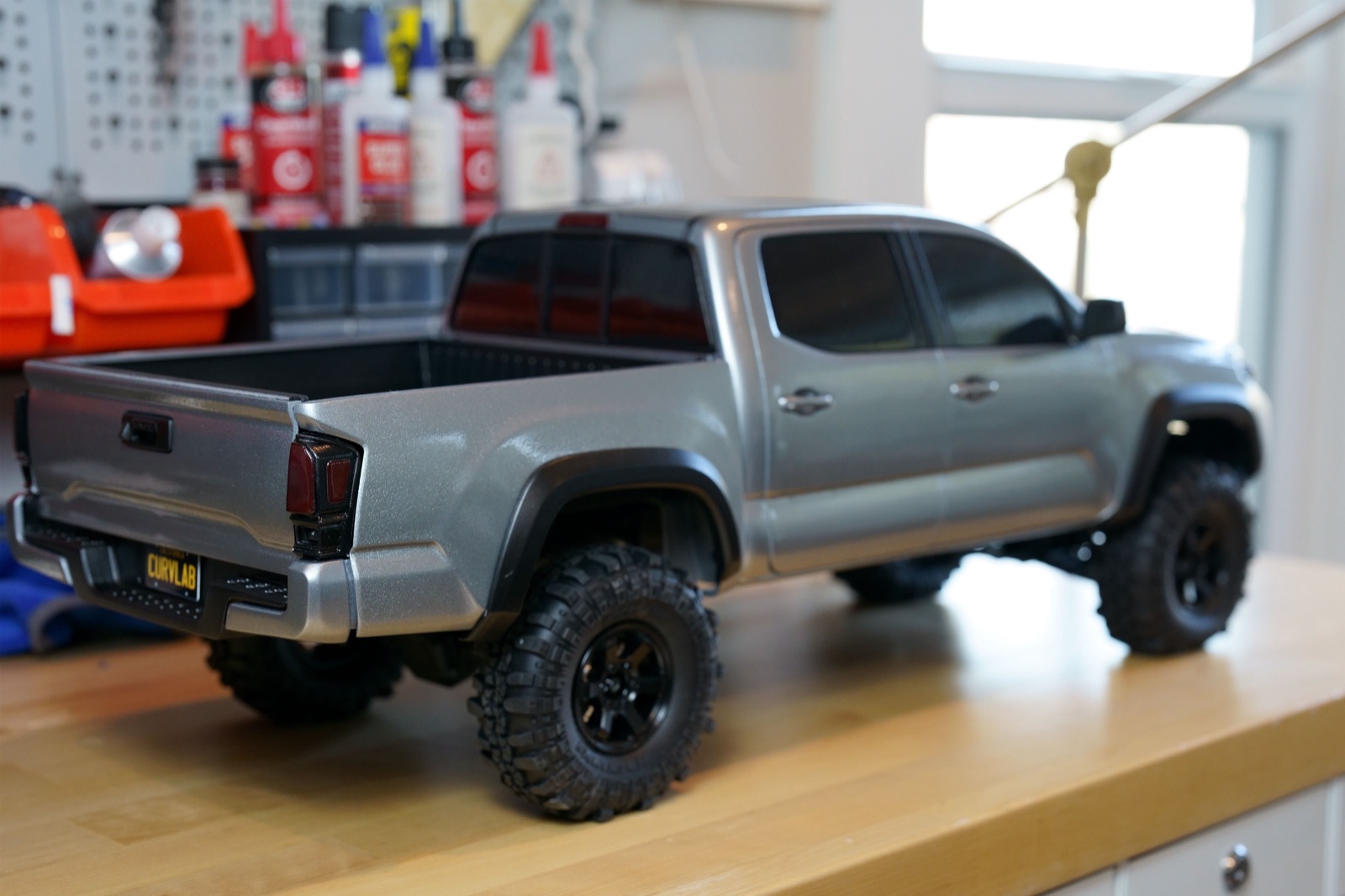 Rear three-quarter view of the finished 3D printed Taco RC truck body with a Curv Lab plate